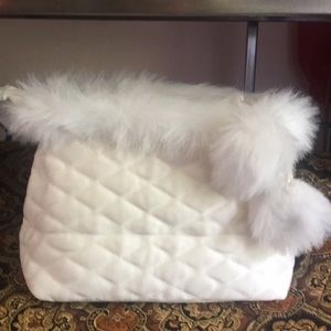 Quilted cream colored travel bag with Pompoms.